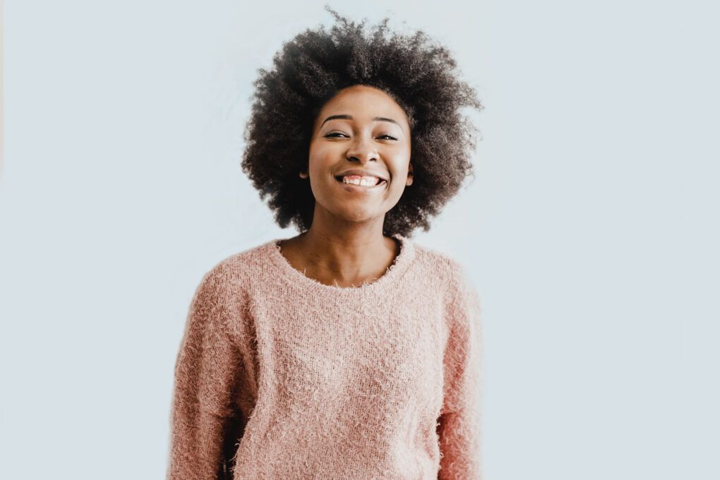 Woman pink top arms crossed